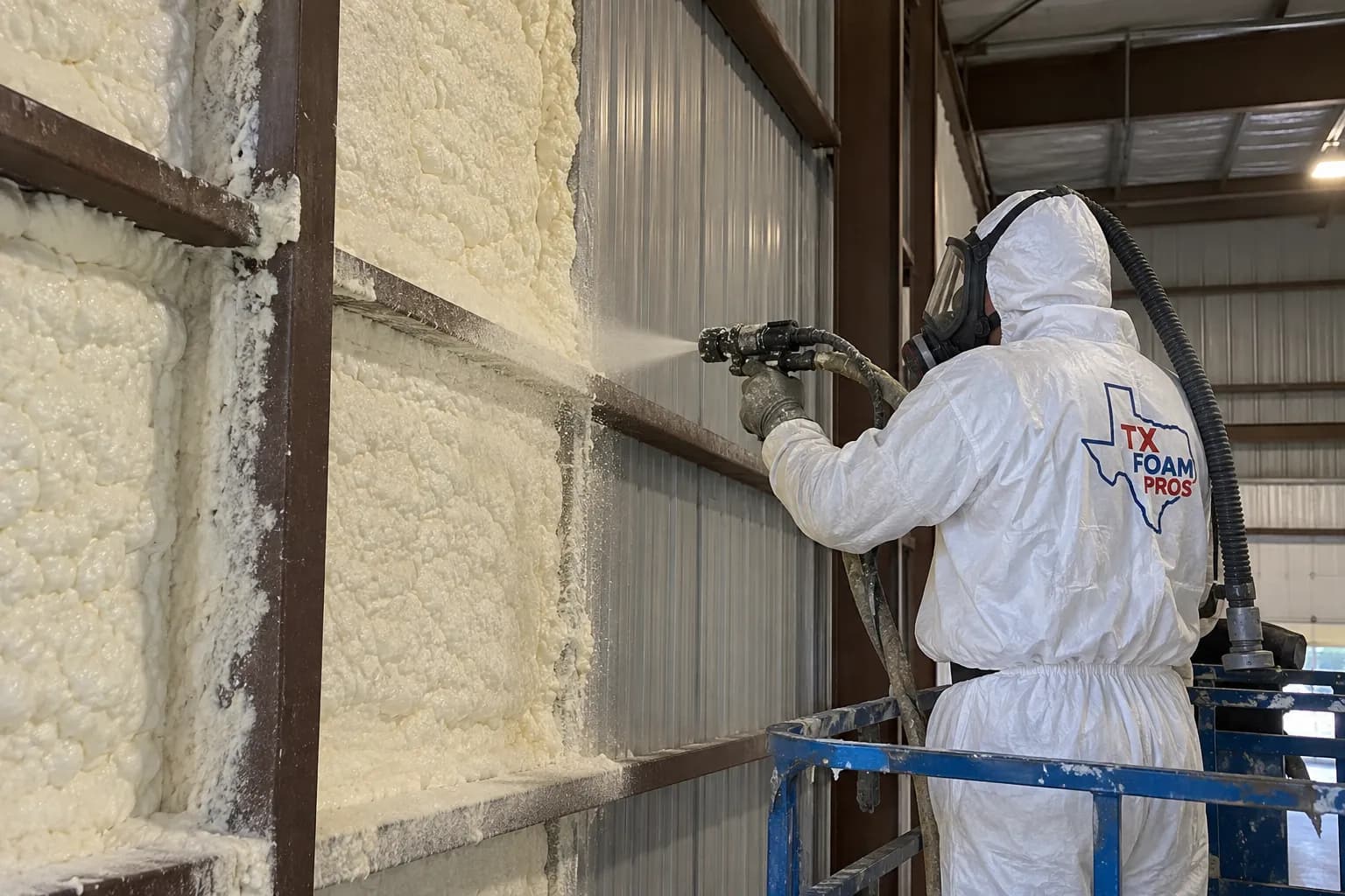 Illustration of a protected branded installer treating an accessible steel warehouse wall bay