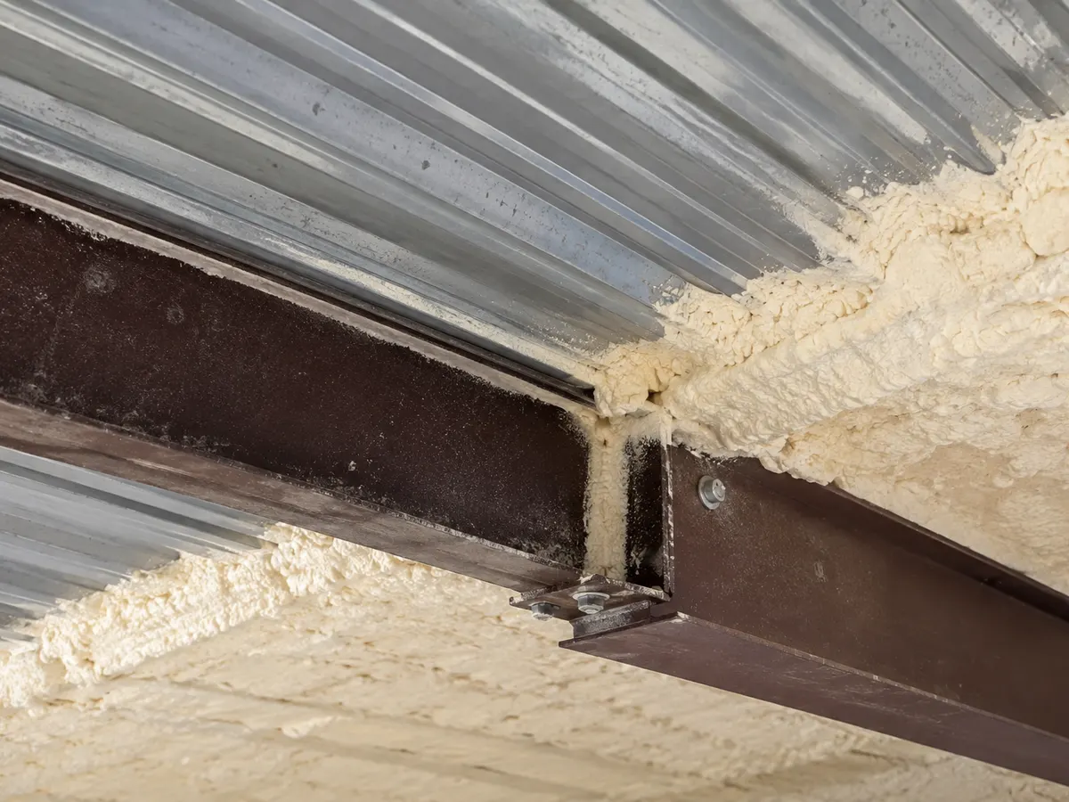 Illustration of a steel roof purlin junction beside selected insulated corrugated surfaces