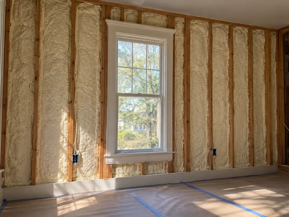 Illustration of opened residential wall cavities around an existing window during a retrofit