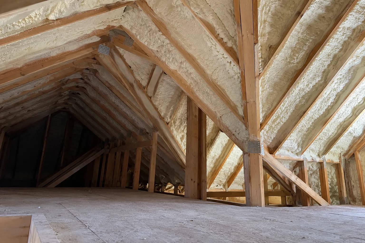 Illustration of new-house attic roof interior with cream foam in high timber rafters and intersecting roof geometry, natural side light