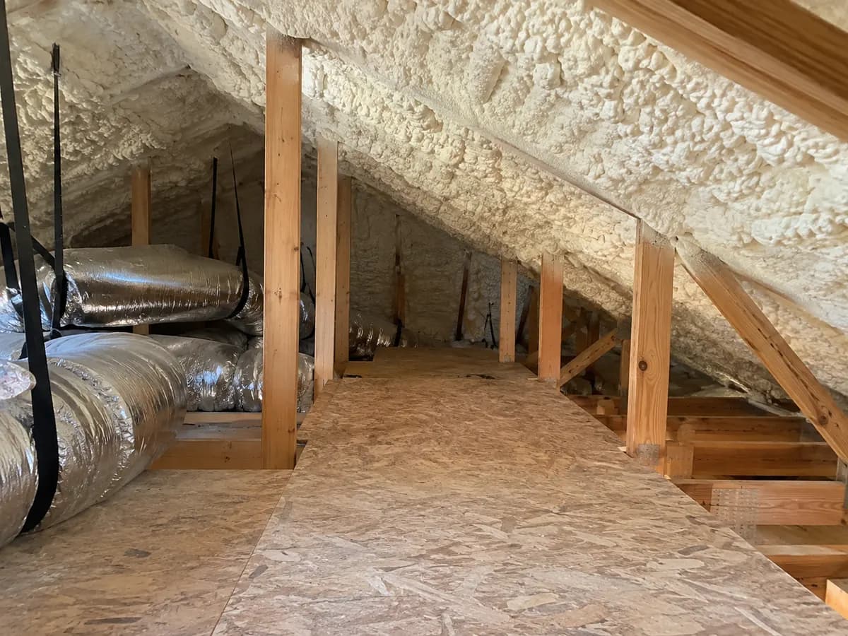 Illustration of attic access platform beneath cream foam roofline, duct service zone left open