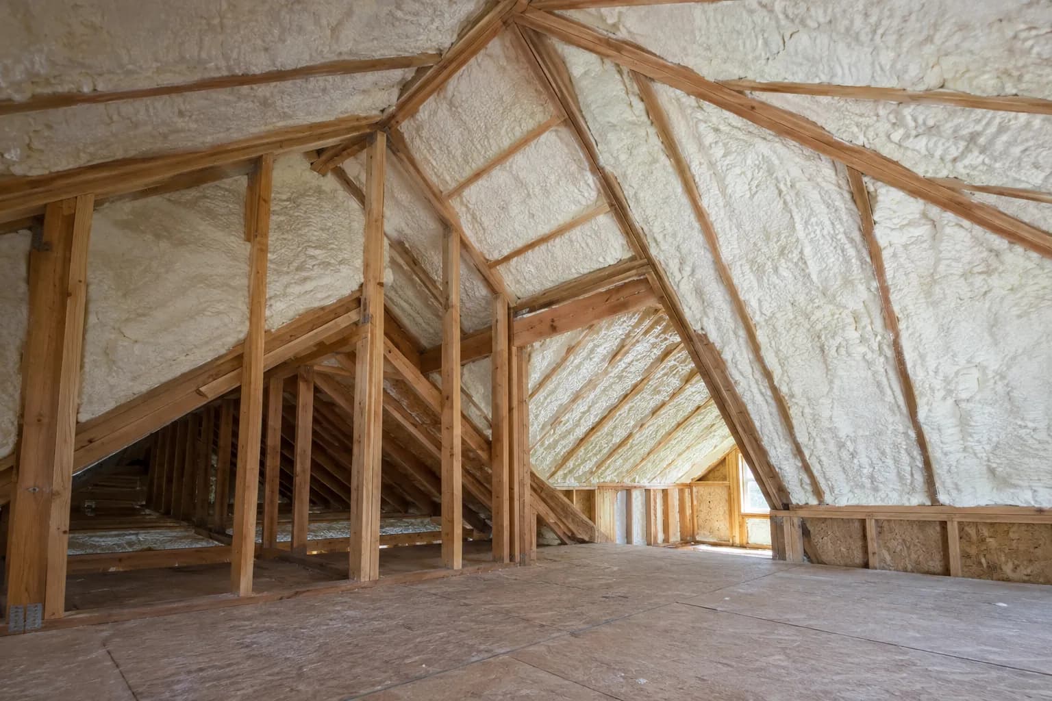 Illustration of residential attic with white foam above a room addition, irregular roof geometry and dry timber, soft side light