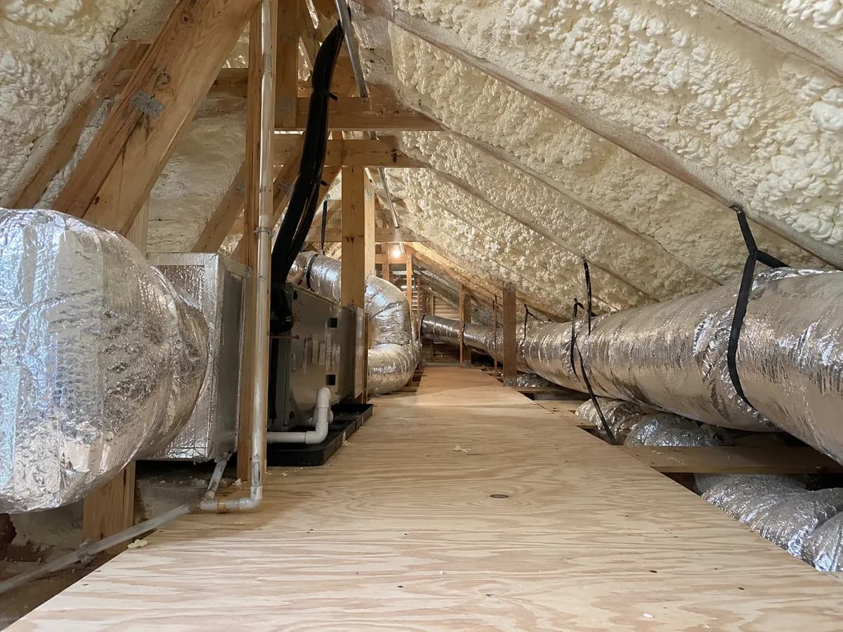 Illustration of existing attic mechanical service corridor under insulated rafters, simple plywood platform