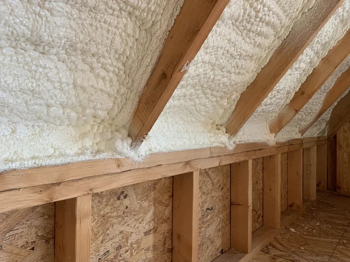 Illustration of close inside view of a roof-to-knee-wall foam connection with dry wood and realistic texture
